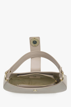 Interior presentation of a beige leather -style women's handbag.