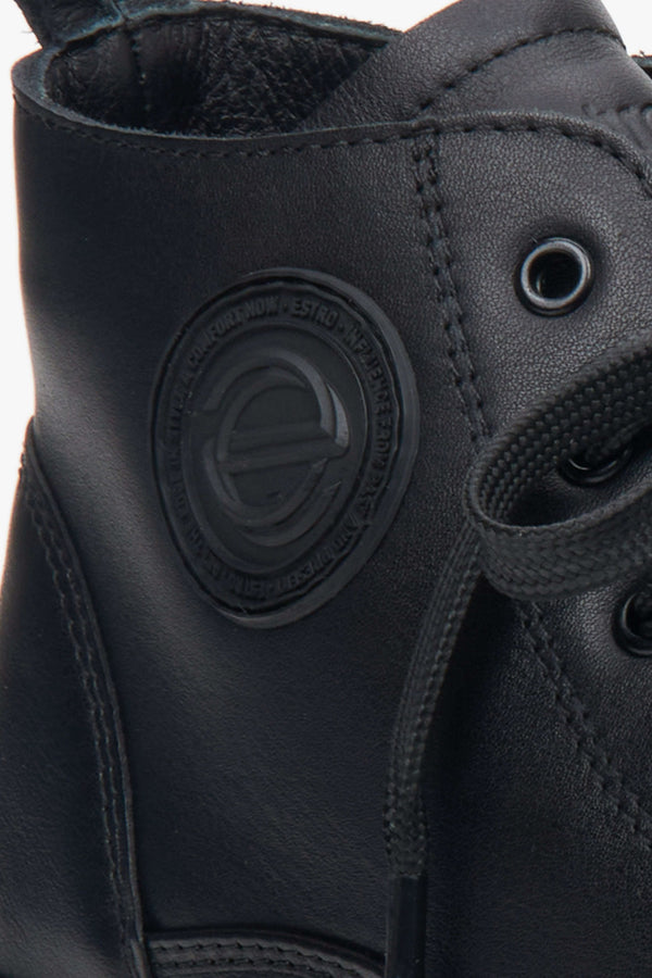 Women's black sneakers - close-up on details.