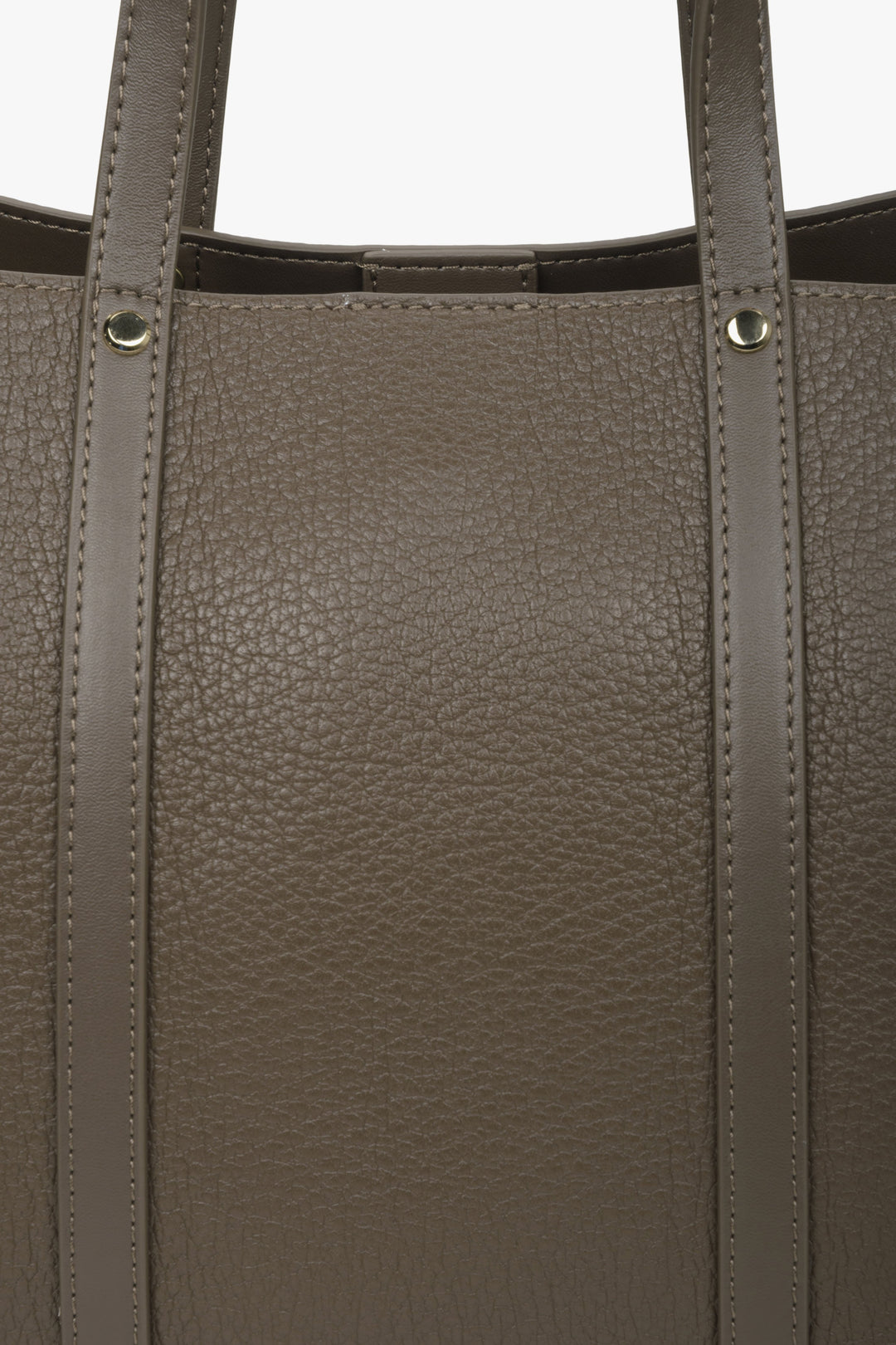 Women's brown shopper bag made of genuine leather - close-up on details.
