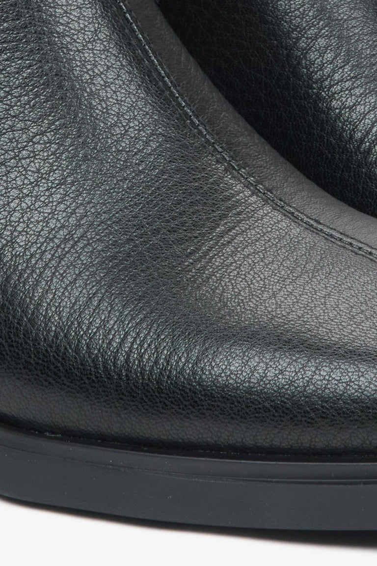 Black leather ankle boots for women – close-up of the leather texture.