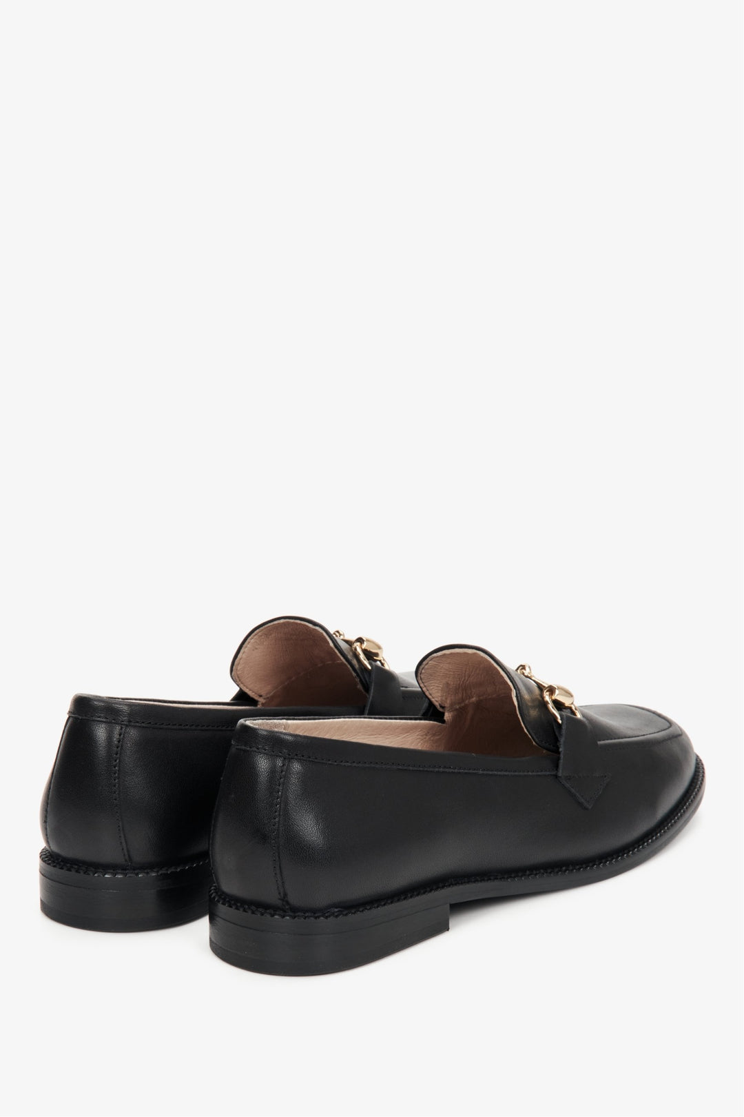 Women's black leather loafers with gold buckle - heel counter.