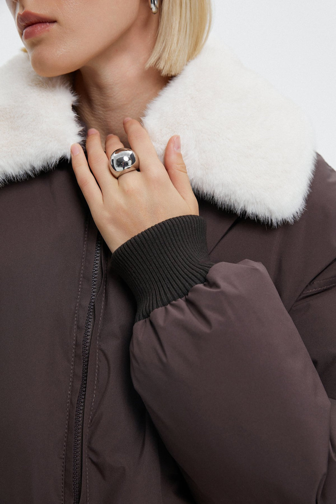 Dark brown women's bomber jacket - close-up of the fur collar.