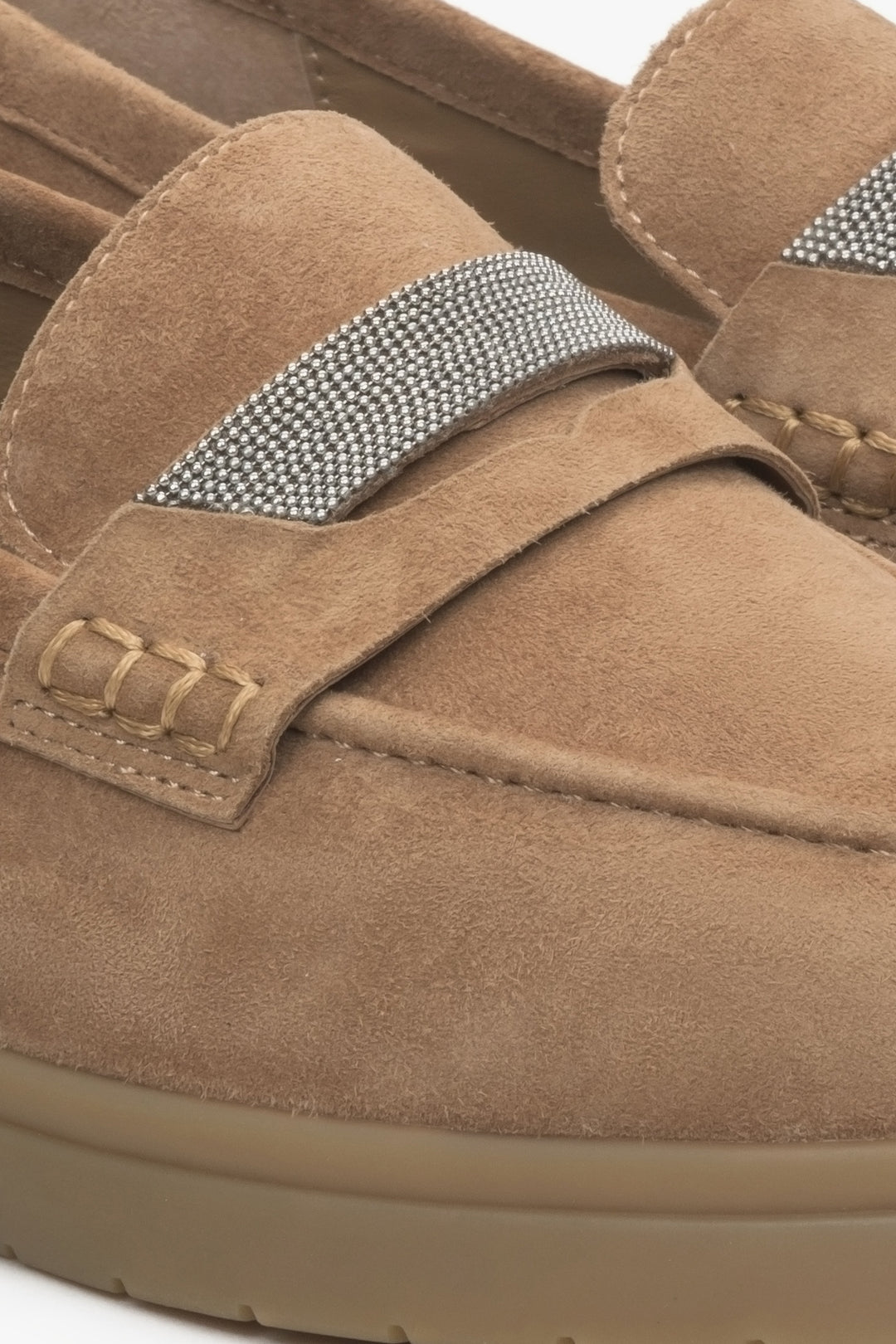 Women's brown velour moccasins by Estro - close-up on detail.