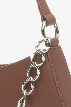 Women's brown bag with decorative chain by Estro - close-up on details.