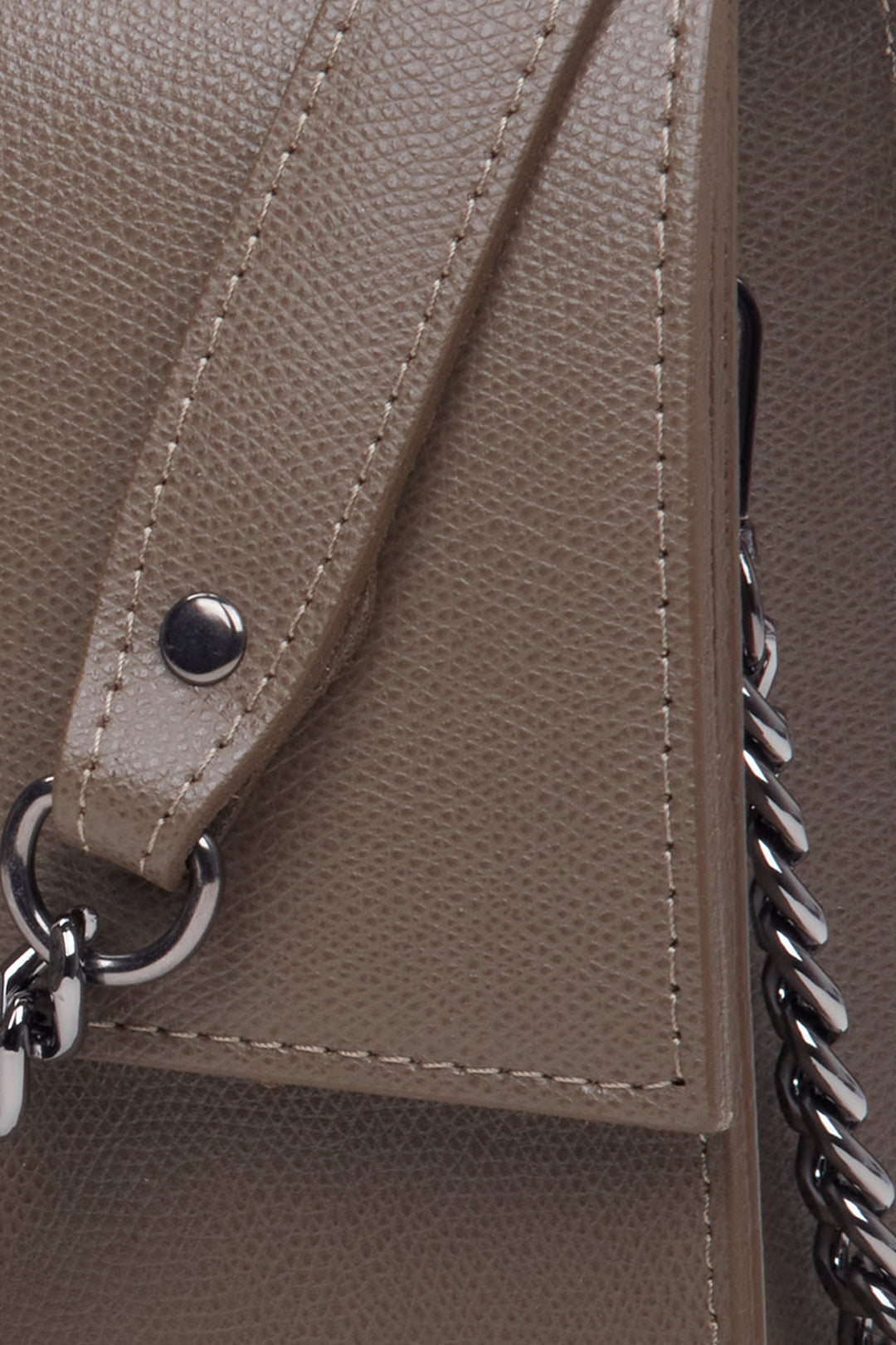Women's brown leather handbag with a flap by Estro - close-up on the details.