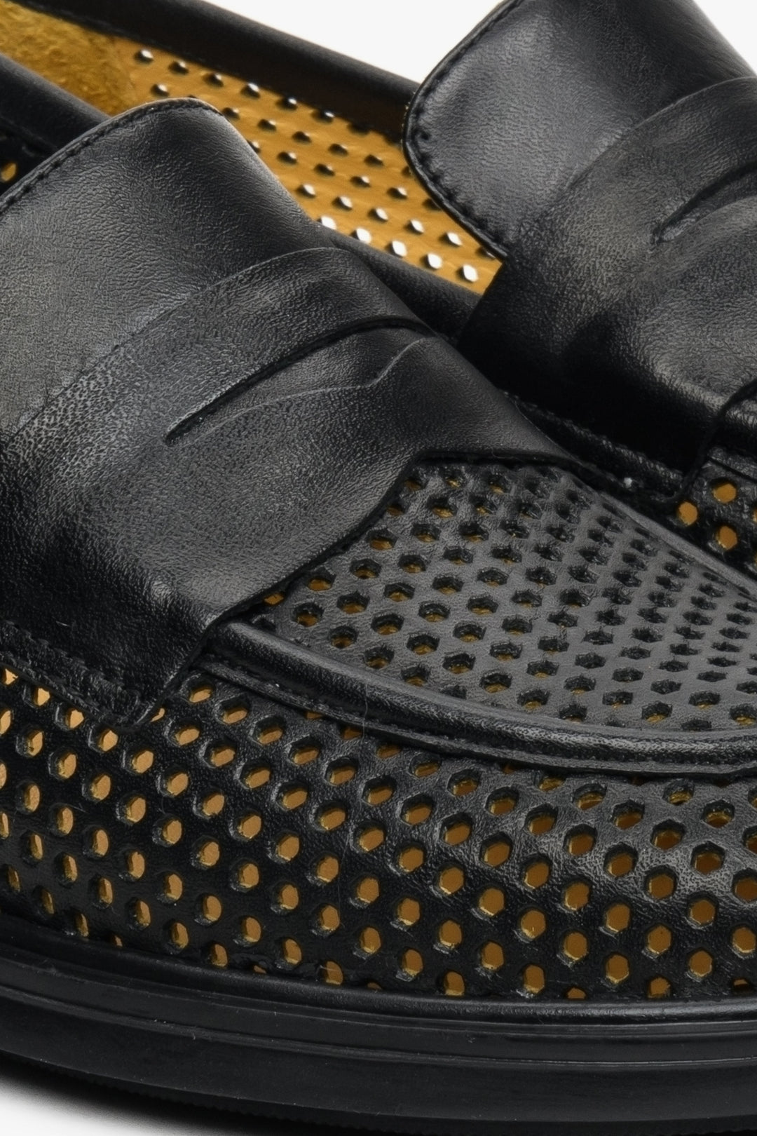 Women's Black natural leather loafers by Estro - close-up on the stitching and perforation pattern.