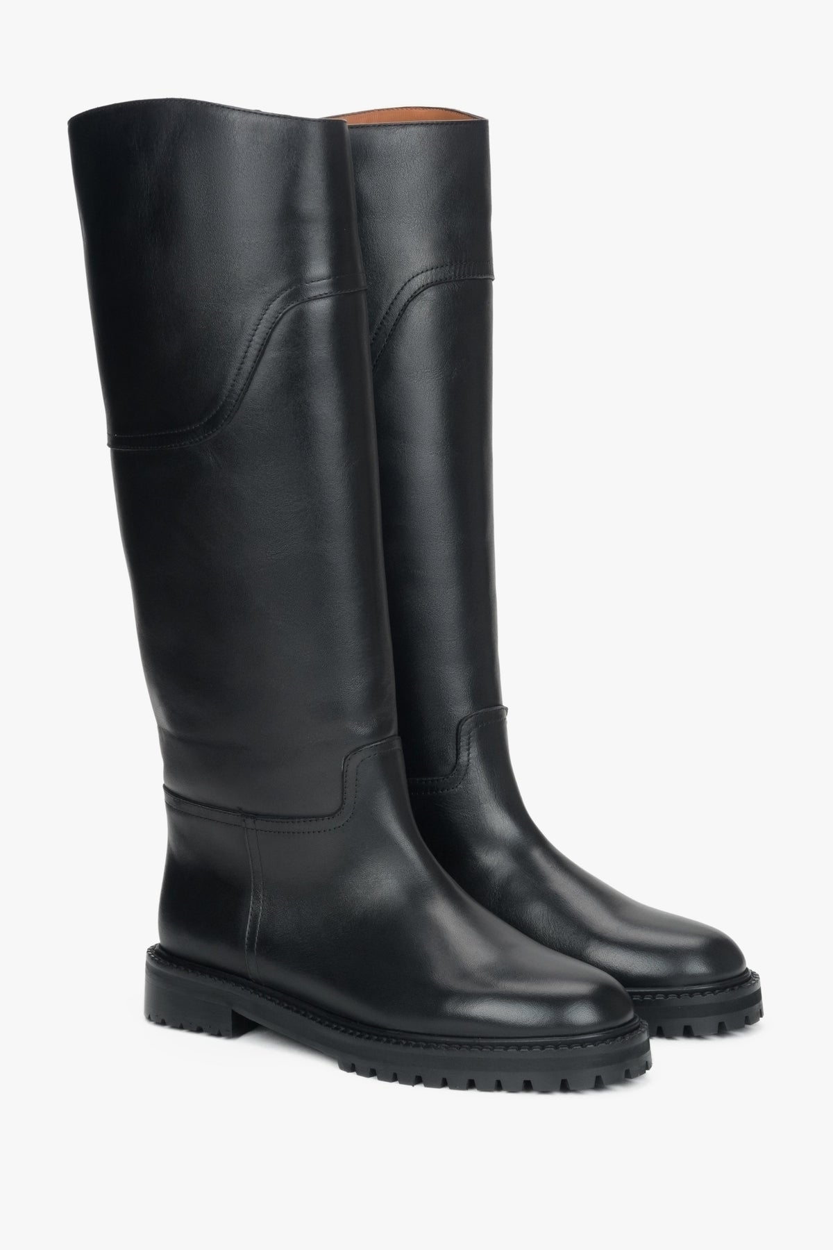 Women's tall black boots made of genuine leather with a flat sole.