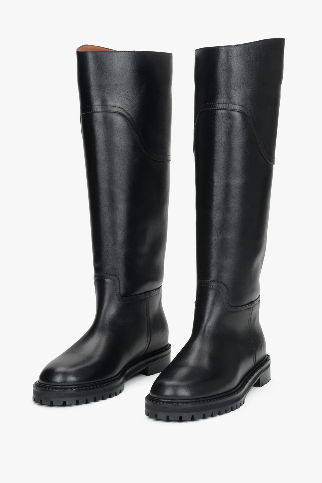 A pair of women's tall black flat boots crafted from genuine natural leather.