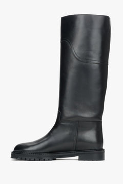 Tall black boots for women, featuring a genuine leather upper and a flat sole.