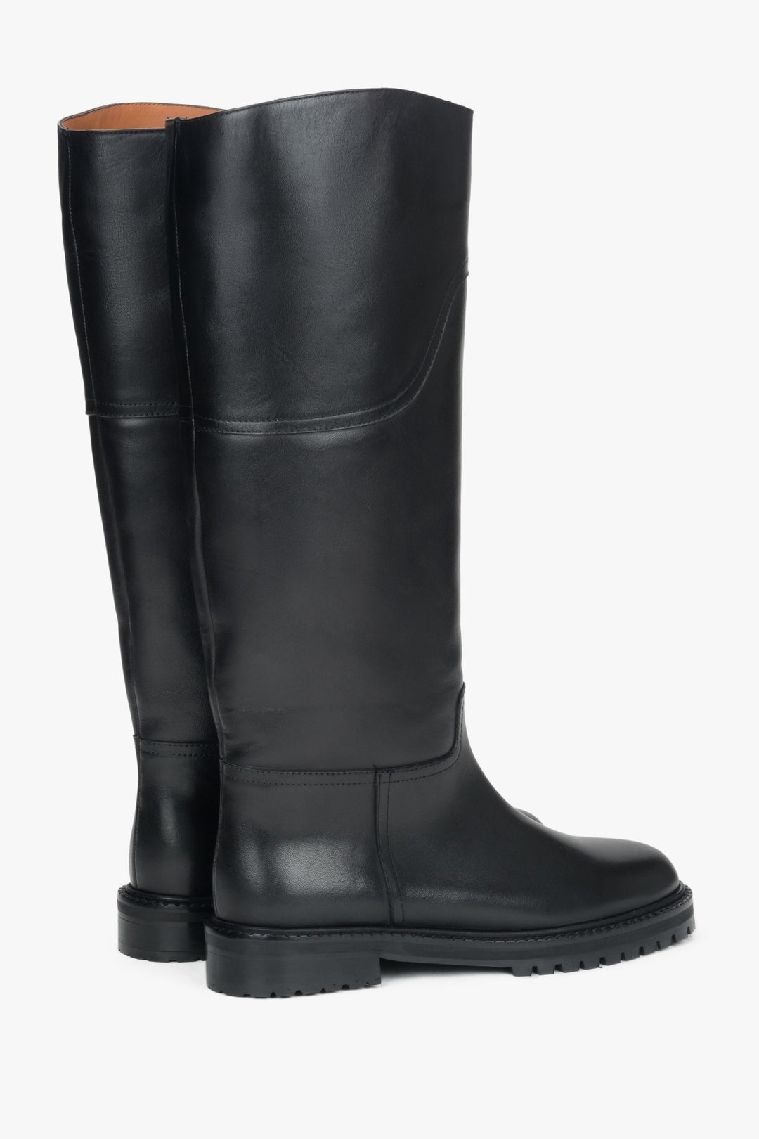 Side profile of women's tall black leather boots, showing the flat sole design.