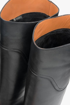 Women's flat-soled tall boots in black, constructed from genuine natural leather.