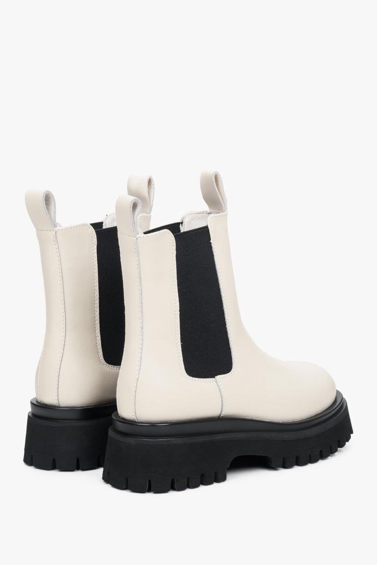 Women's black and white leather ankle boots for spring and autumn - close-up on the shoe's profile and heel.