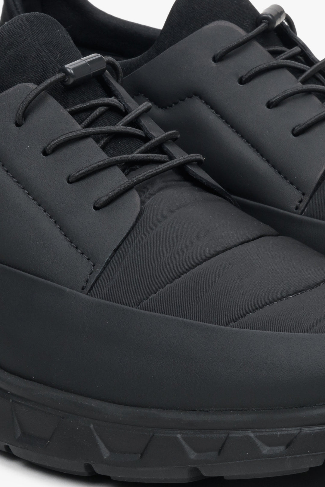 Men's black sneakers made of mixed materials by Estro - close-up on the detail.