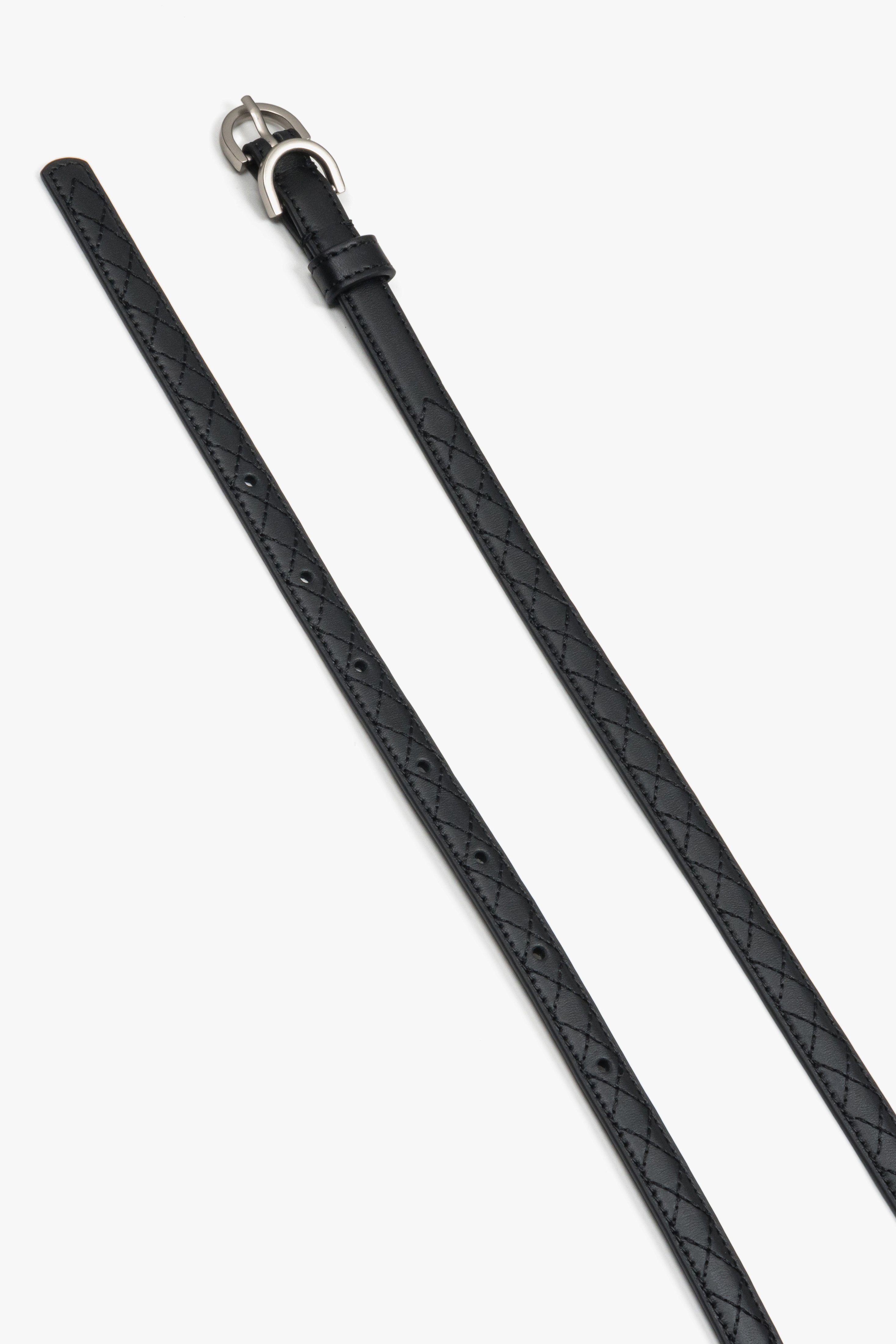 Embossed braided pattern on a black natural leather belt.