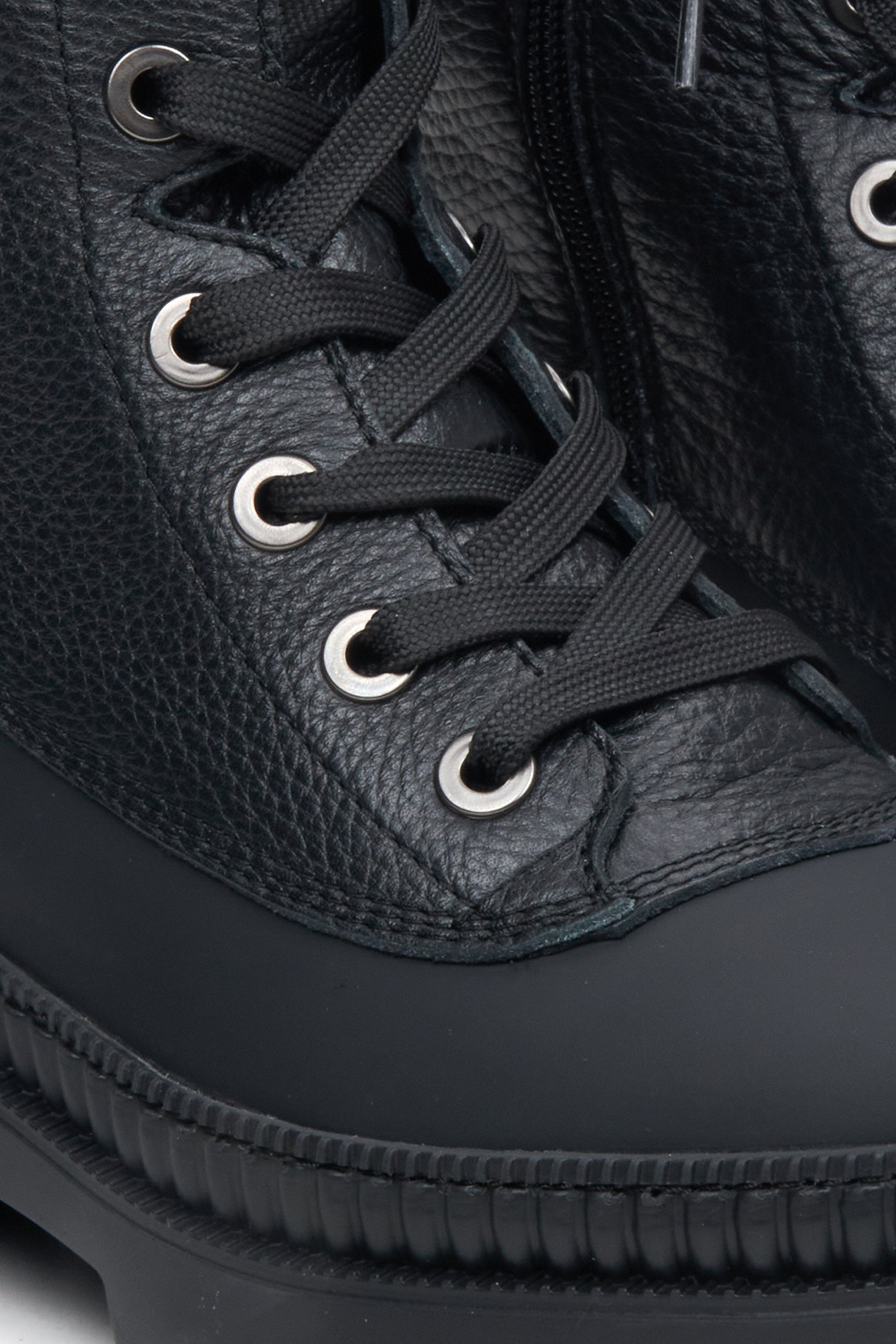 Women's black leather ankle boots - close-up of the decorative lacing.