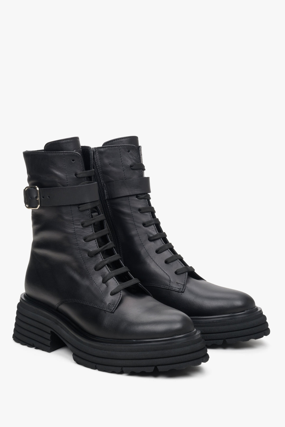 Women's black leather ankle boots with decorative strap by Estro.