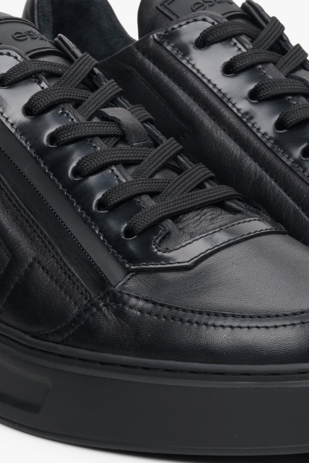 Men's black leather sneakers by Estro - close-up on the detail.