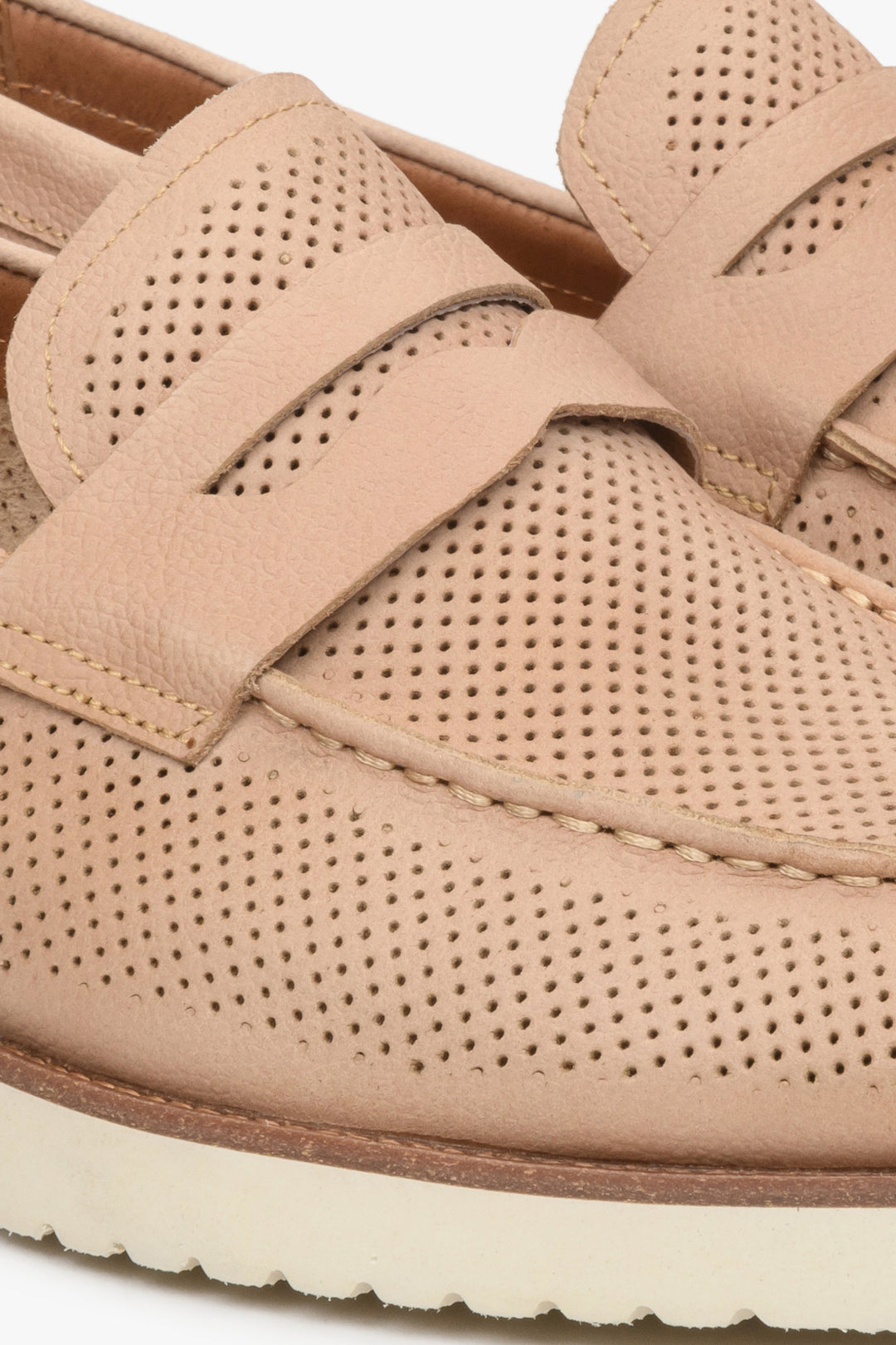Men's beige penny loafers with perforation - close-up on details.