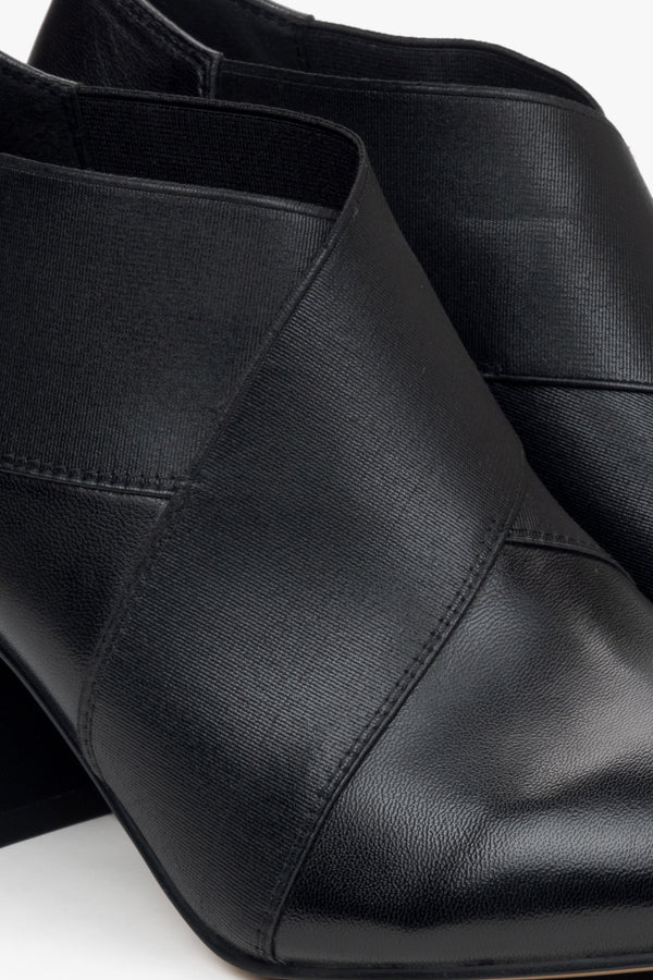 Low-top black ankle boots for women with a pointed toe and stable block heel – close-up of the details.