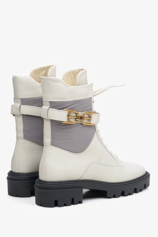 Beige-grey Estro women's leather ankle boots with a decorative buckle - close-up on the heel and side profile.