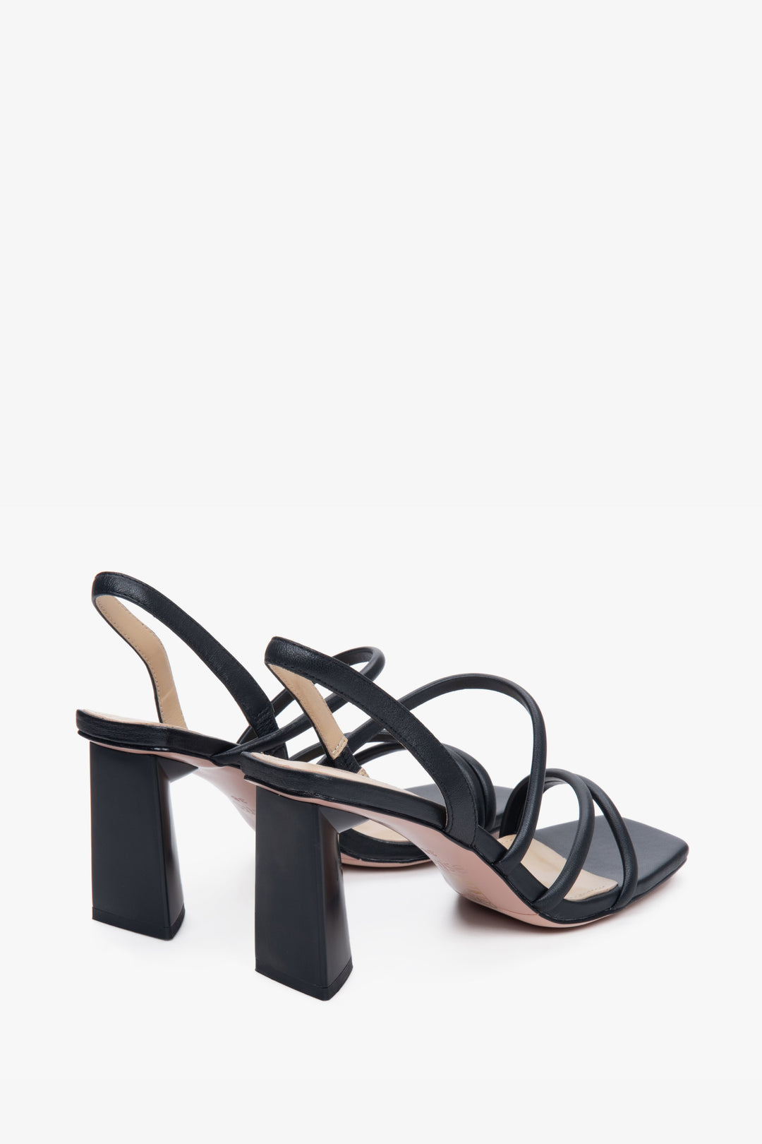 Black strappy women's leather sandals on a block heel - a close-up on the bottom line.