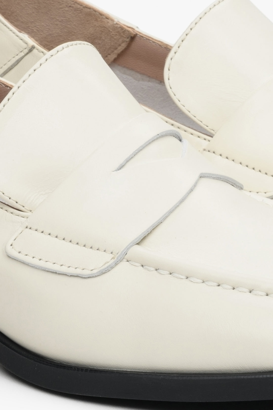 Women's white leather loafers by Estro - close-up on the stitching pattern.