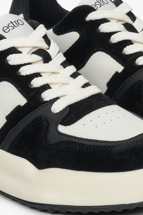 Women's black and white sneakers - close-up on details.
