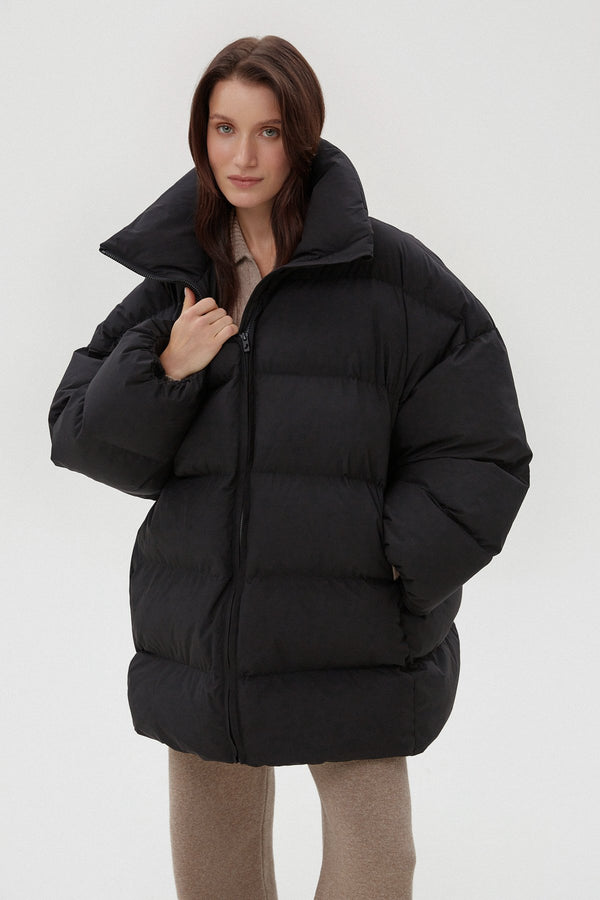 Warm women's black puffer jacket by Estro.