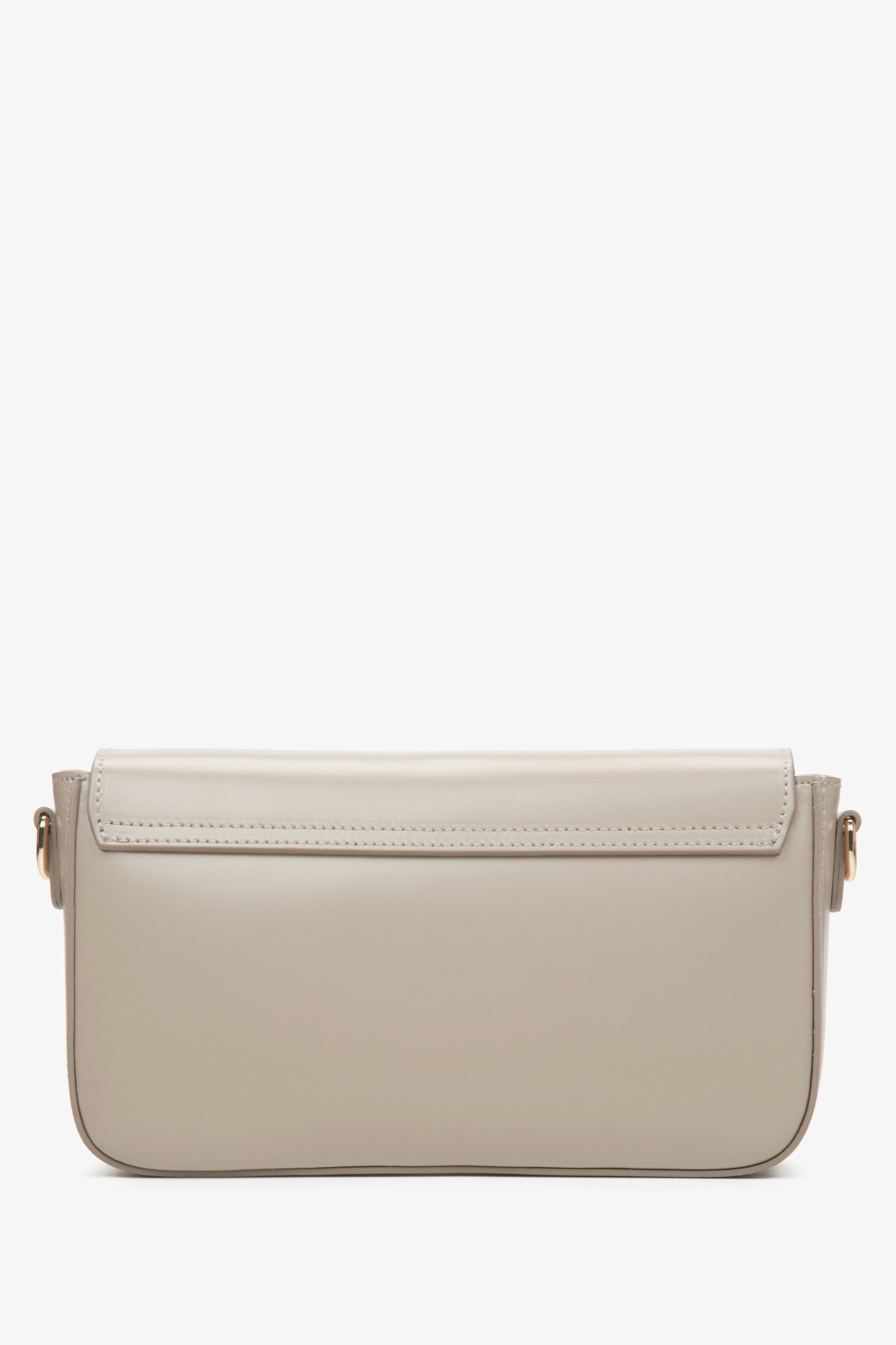 Small women's handbag in beige, styled as a baguette.