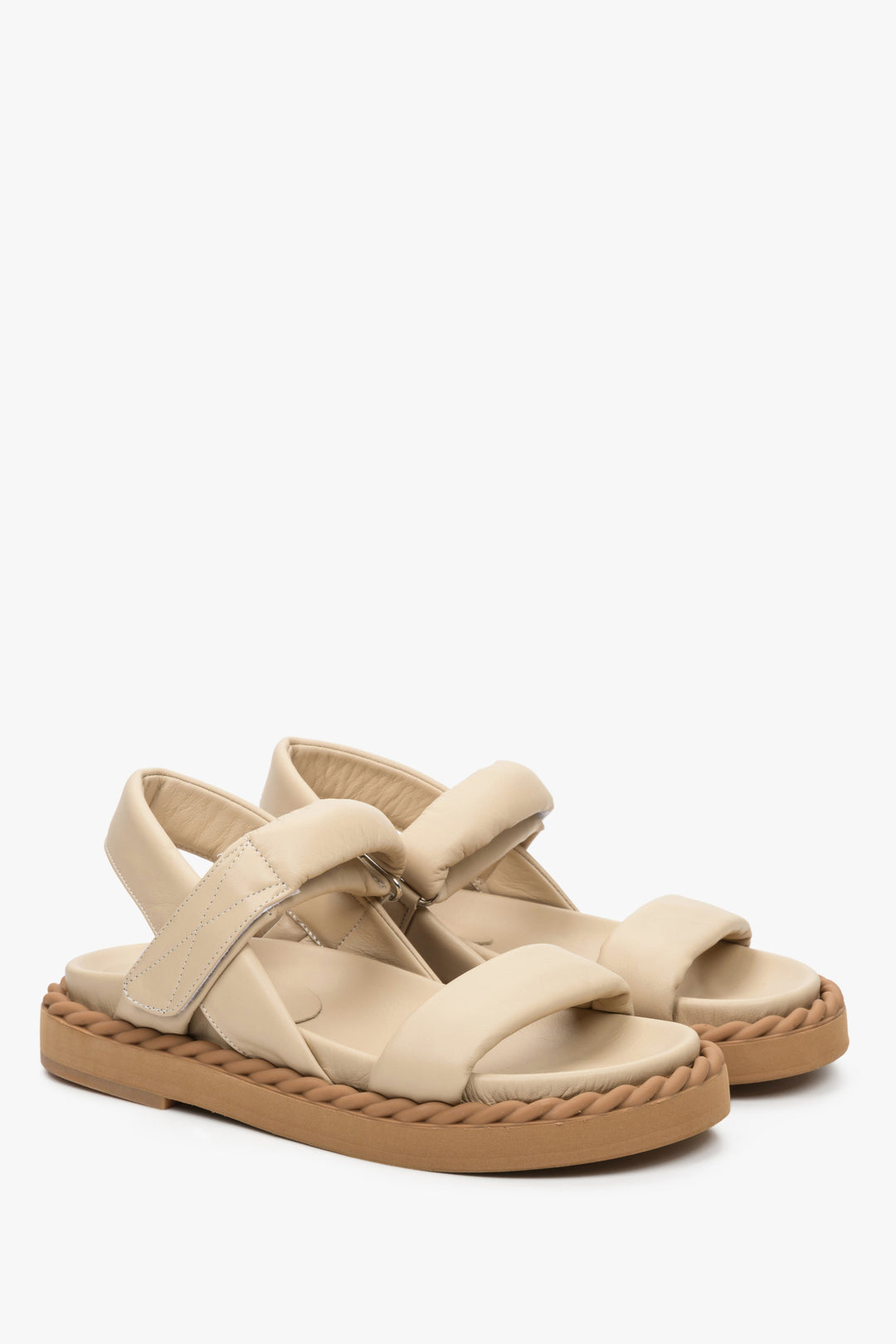 Women's sandals for summer in beige colour made of natural leather on a comfortable sole.