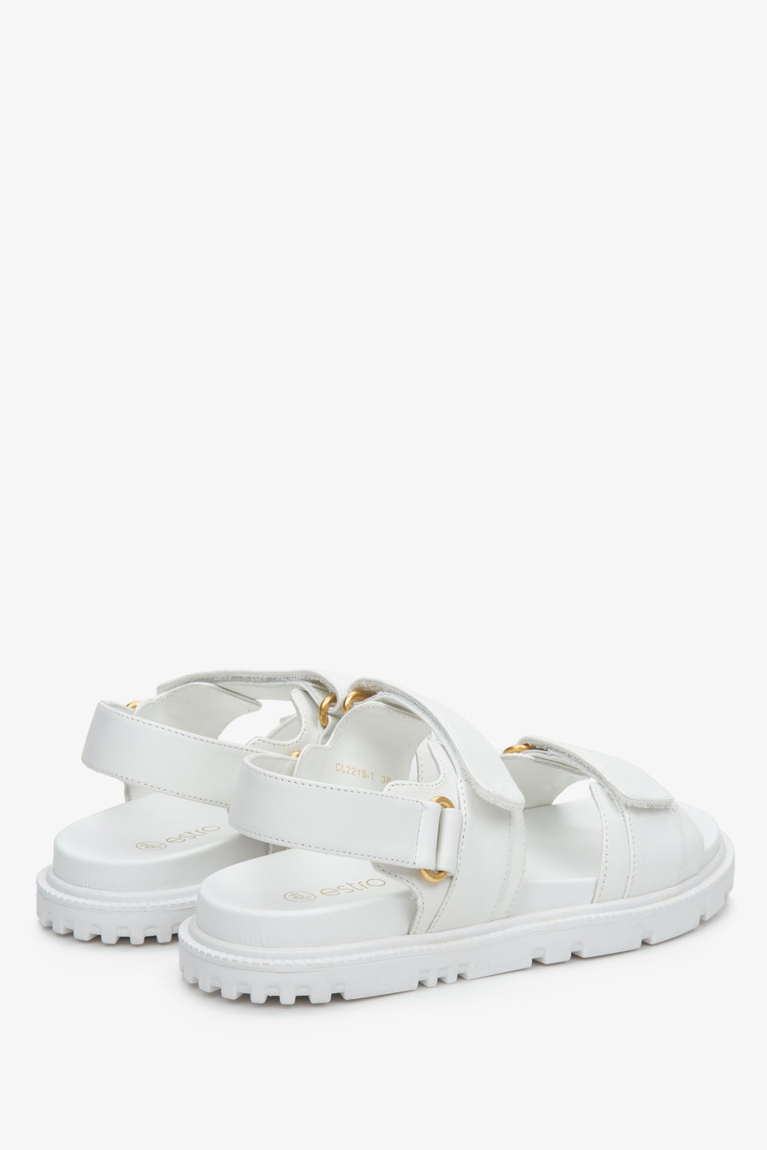 Women's white leather sandals with a soft sole and gold elements - close-up on the side and heel line.