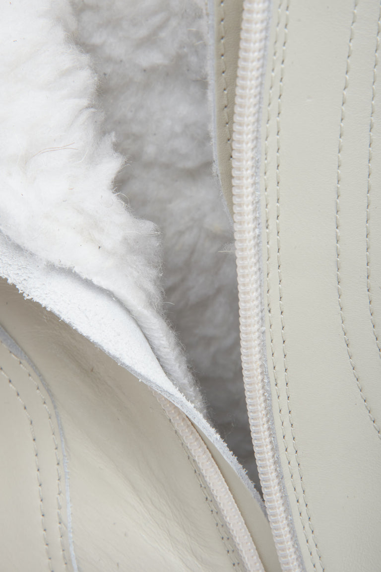 Women's leather light beige winter boots with warming lining by Estro - close-up of the interior of the shoe.