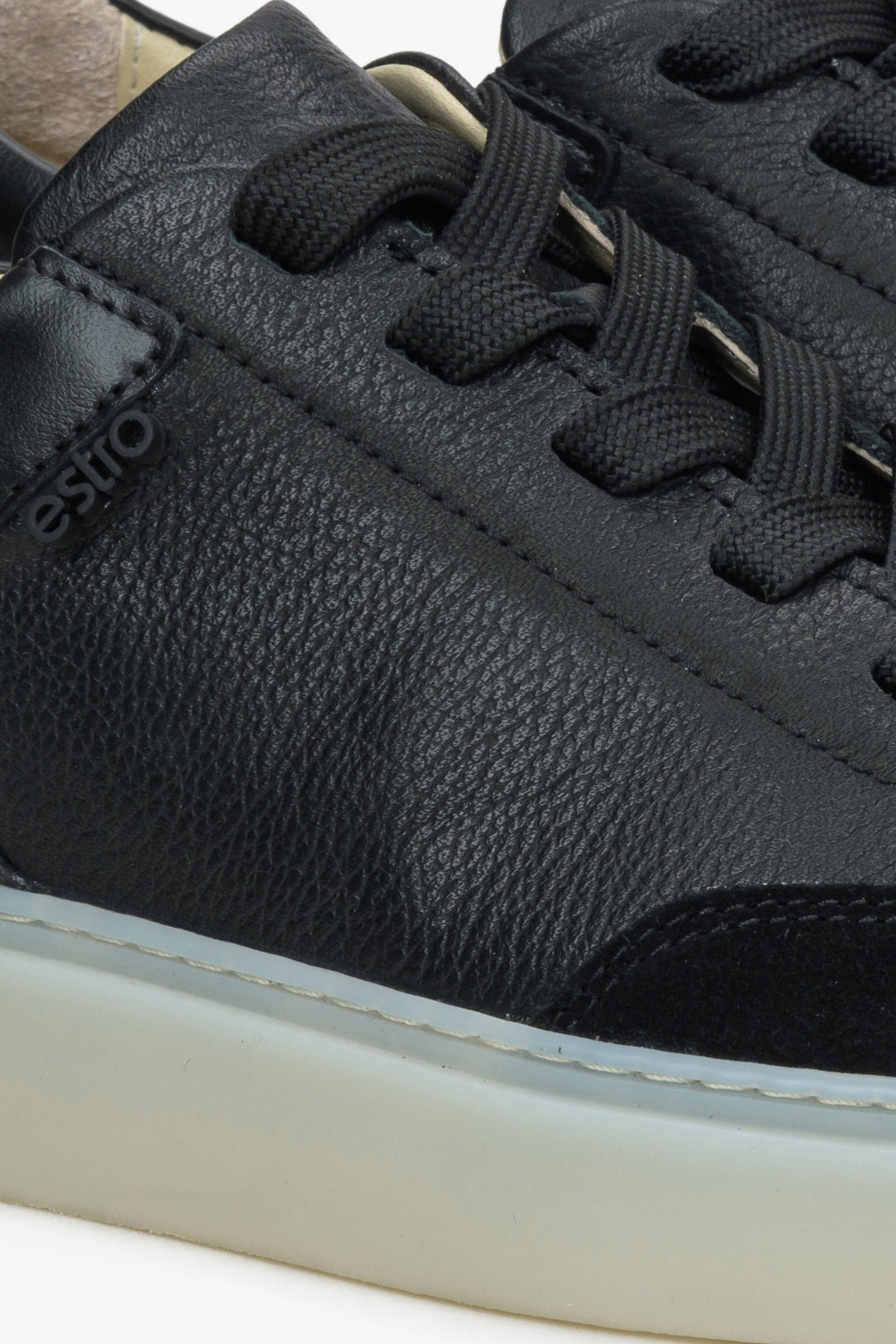 Black women's sneakers made of genuine leather and velour by Estro - close-up on details.