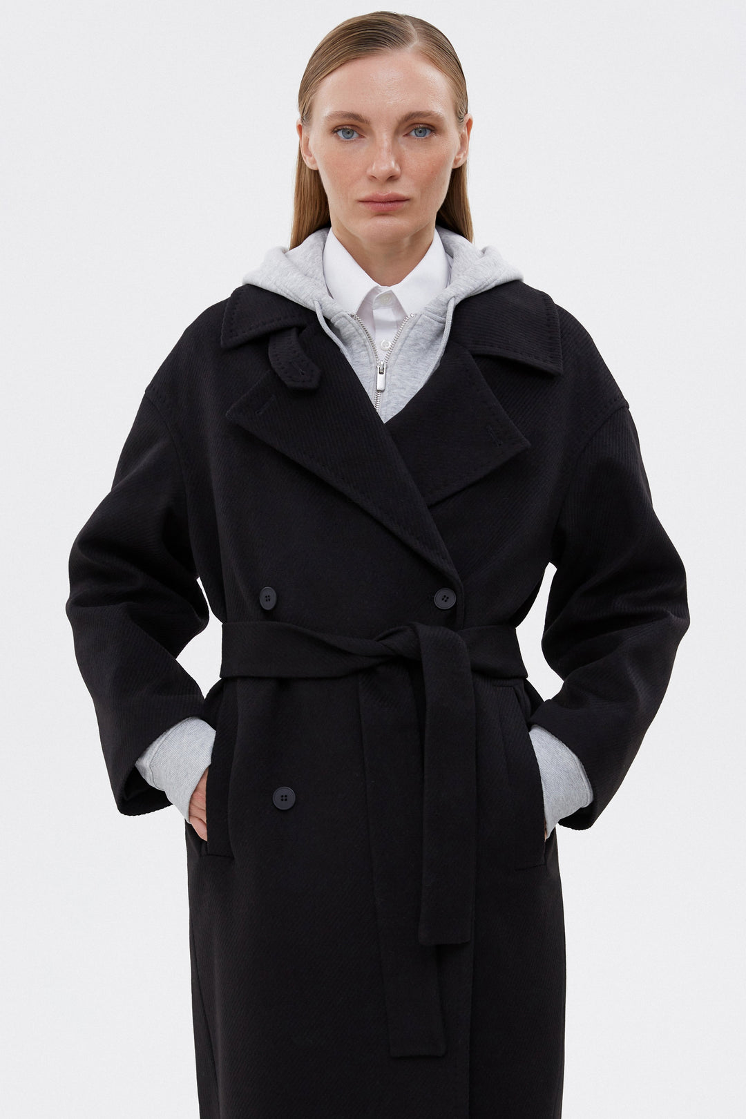 Women's long black coat, v-shaped neckline.