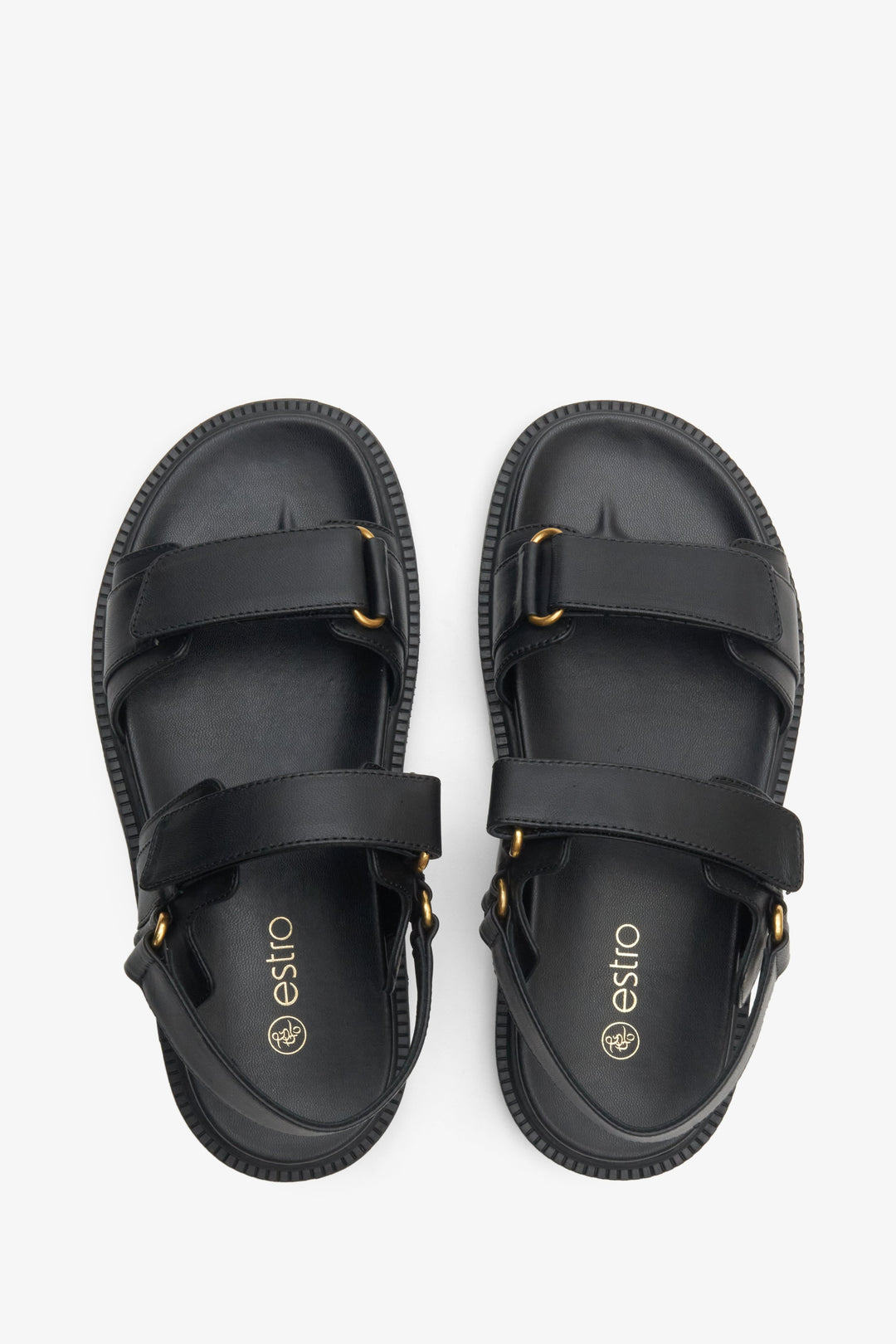  Women's black sandals made of genuine leather with a flexible sole and golden elements.