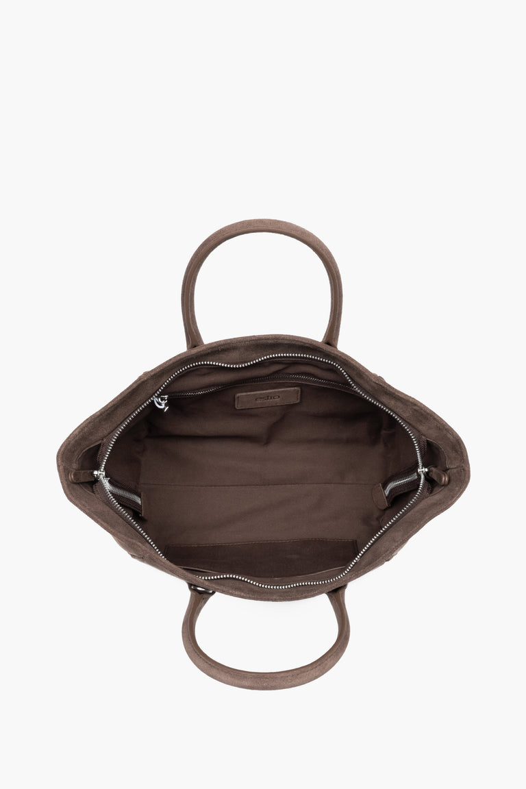 Top view of the open zippered main compartment, showing wide access to the lining and functional internal pockets.