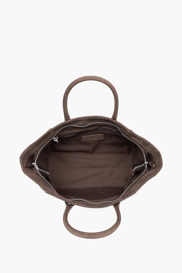 Top view of the open zippered main compartment, showing wide access to the lining and functional internal pockets.