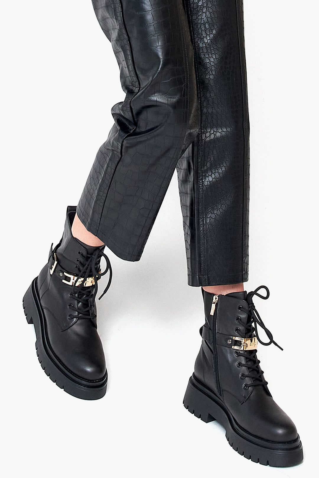 Winter women's boots in black natural leather - footwear presentation on a model.