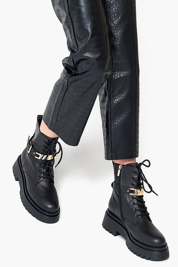 Winter women's boots in black natural leather - footwear presentation on a model.