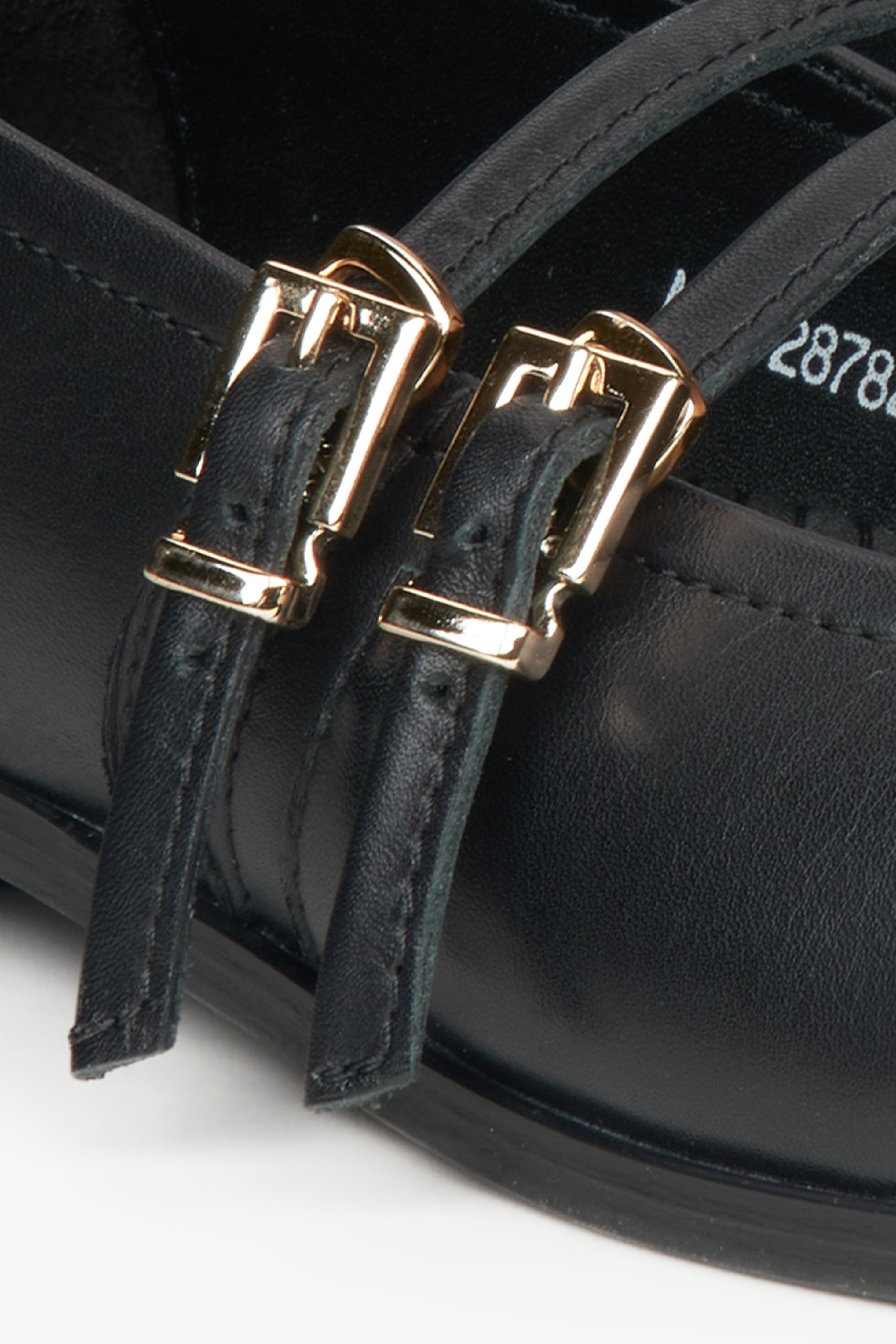 Women's black leather ballerinas - close-up on the buckle.