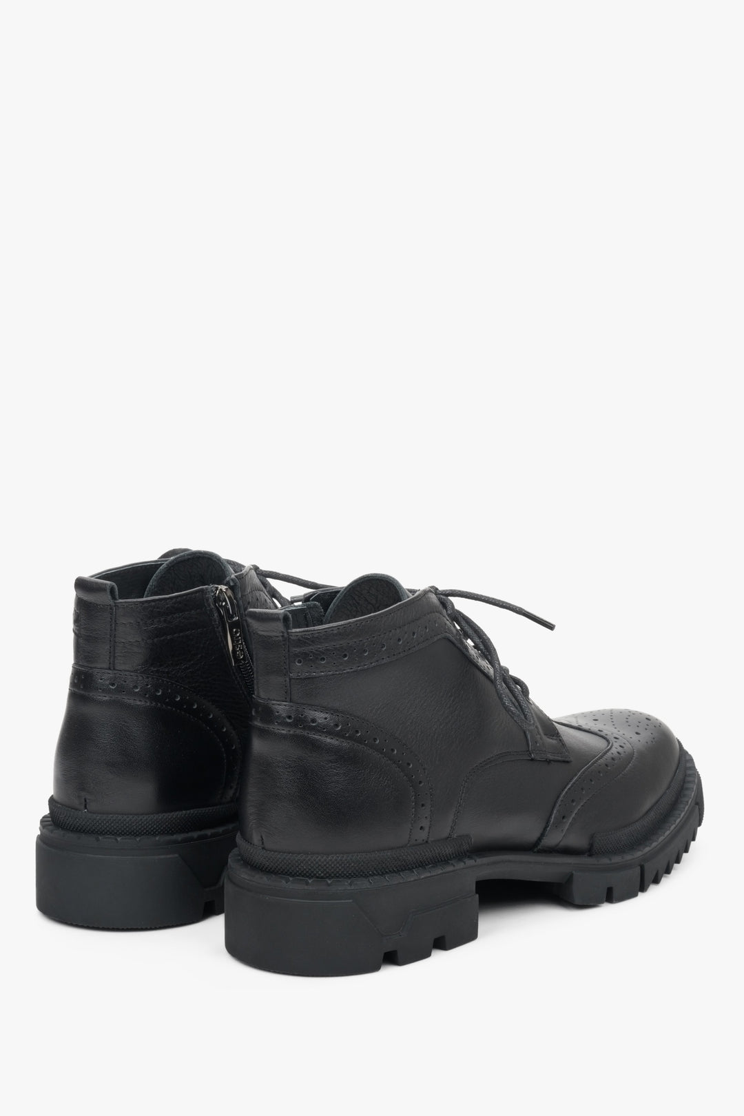 Elevated women's ankle boots made from genuine black leather - close-up of the heel counter and the back of the shoe.