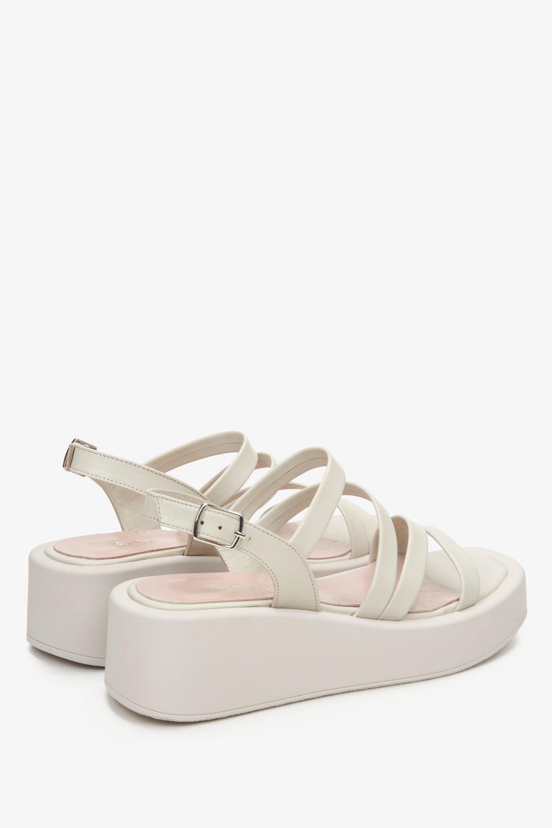 Women's leather light beige wedge sandals by Estro - close-up on the side line and heel of the shoe.