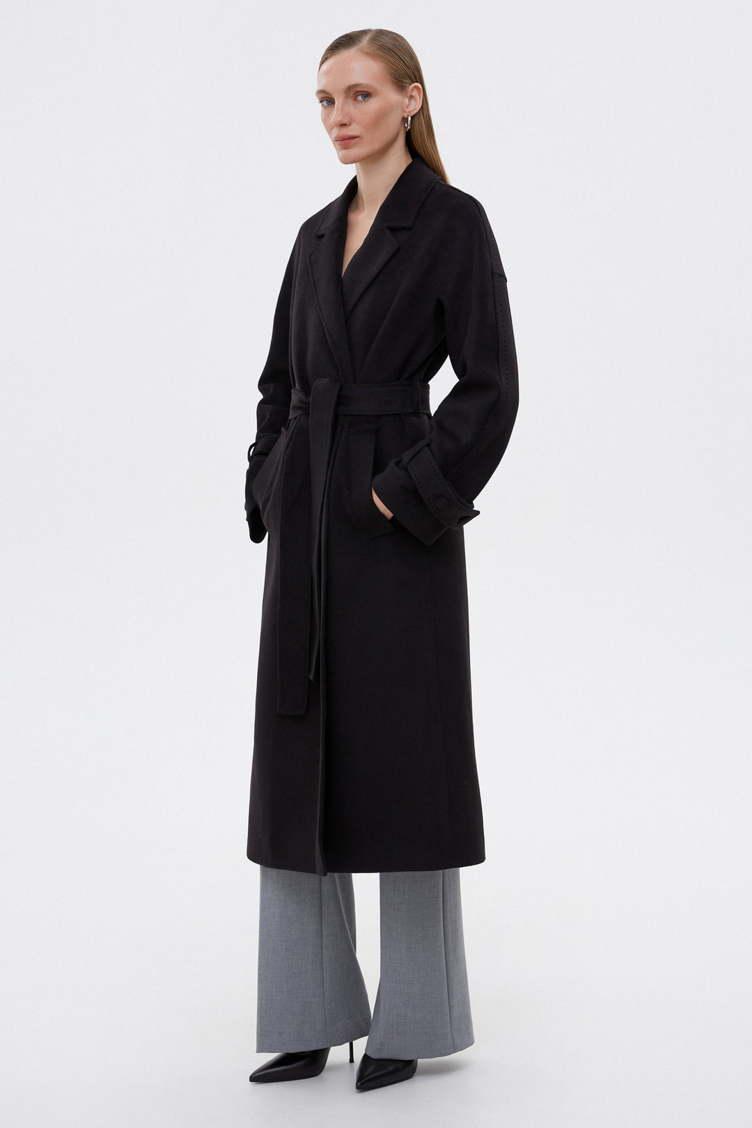 Long classic black coat with a belt by Estro.