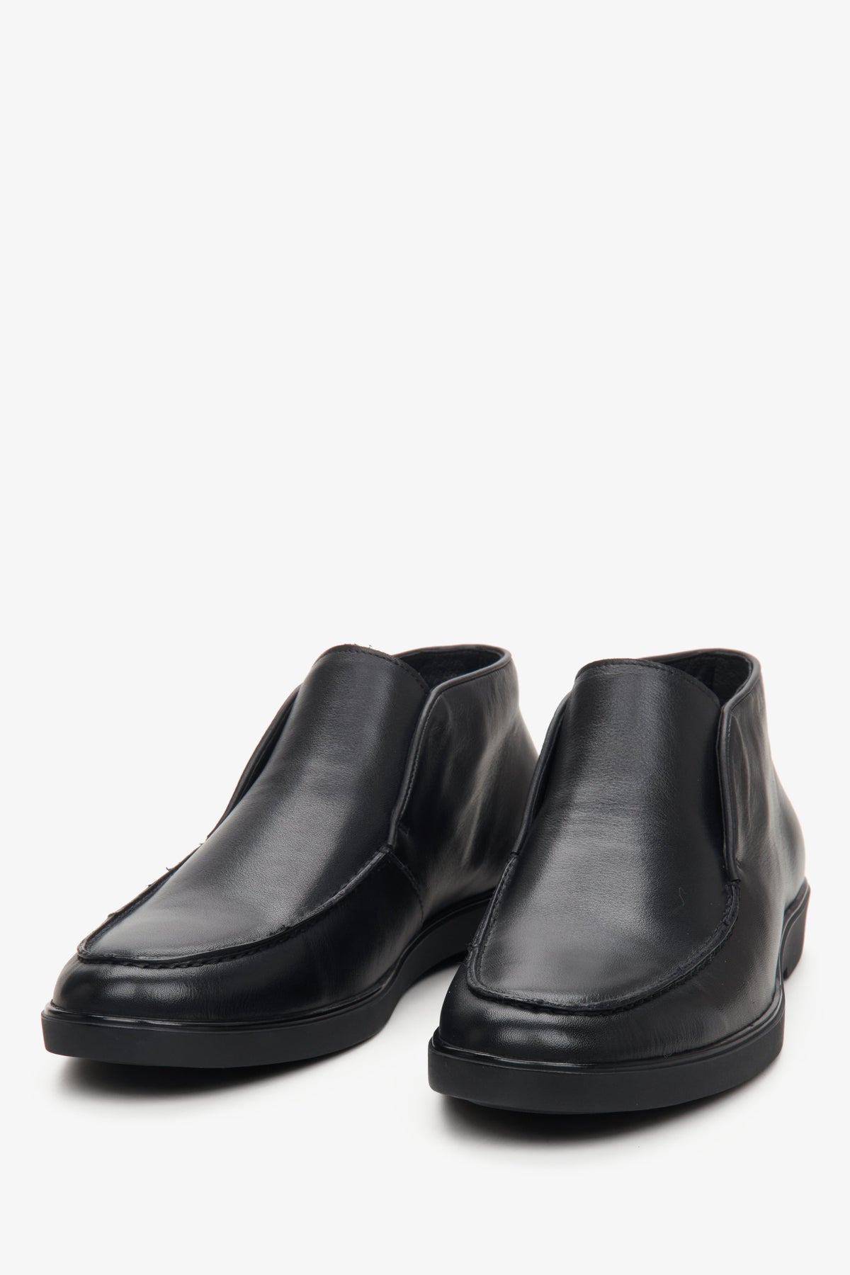 Men's black boots made of genuine leather in black color - close-up on the toe of the shoe.