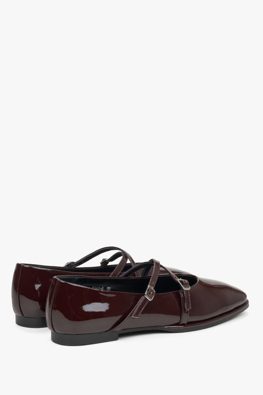 Women's burgundy patent leather ballet flats with a buckle.