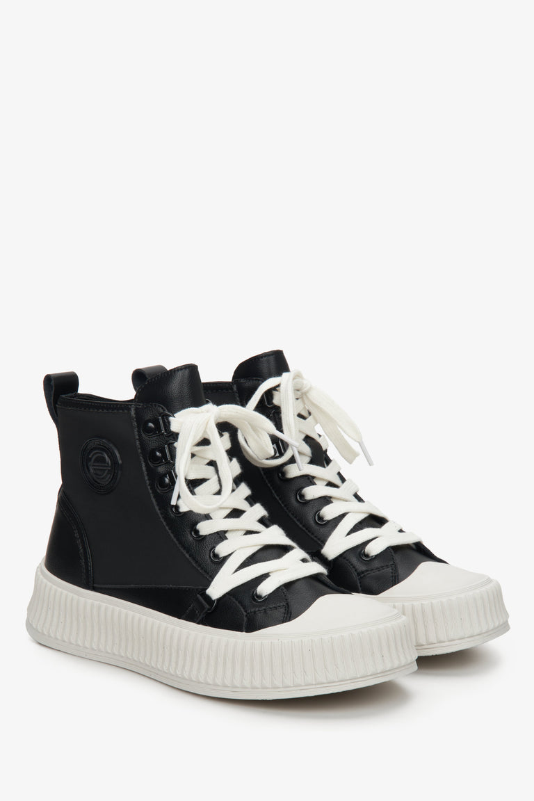 Women's black leather sneakers with laces.