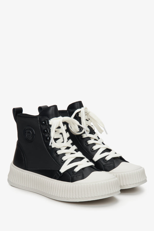 Women's black leather sneakers with laces.