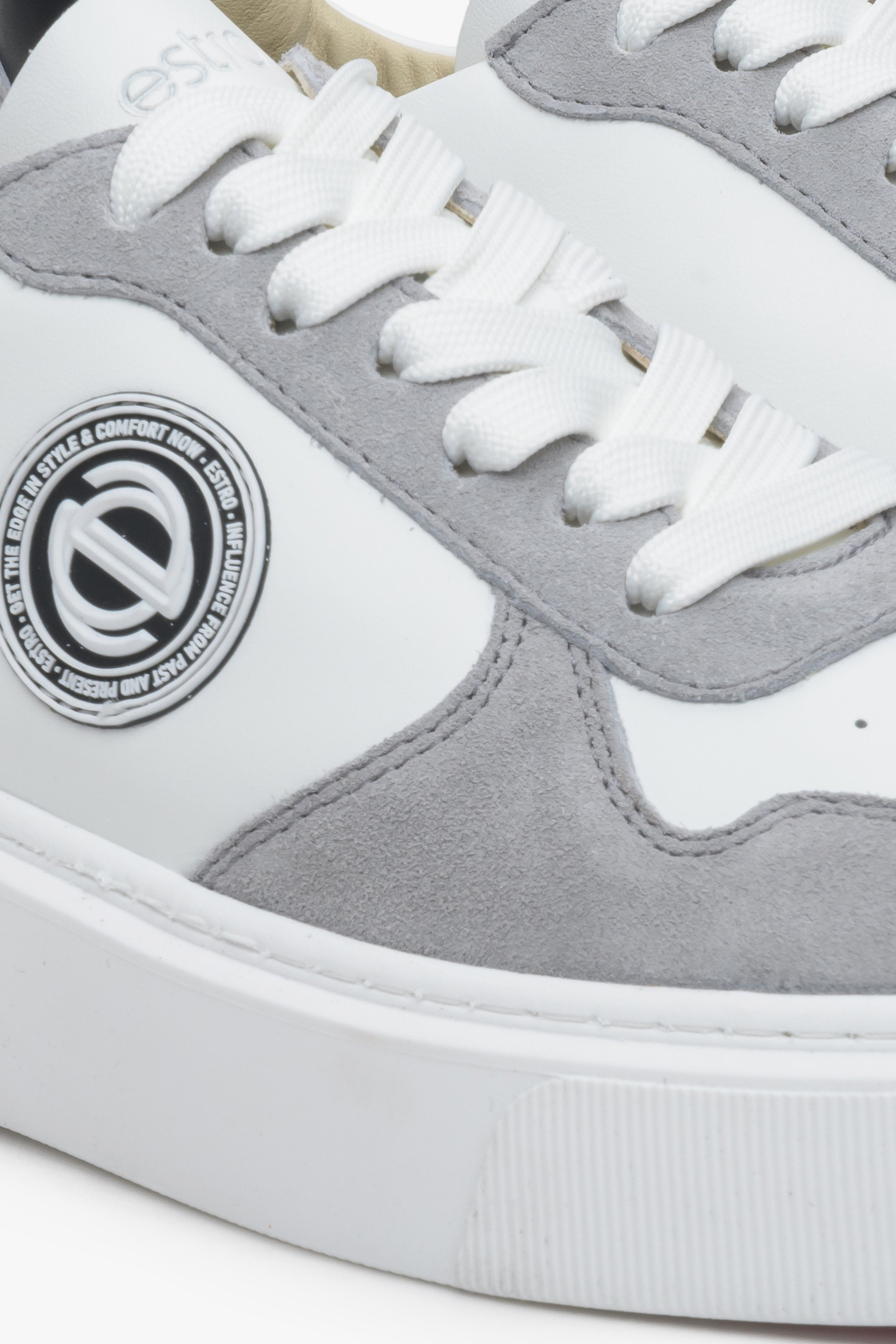 Leather women's sneakers by Estro in white and grey color with laces - close-up on the details.