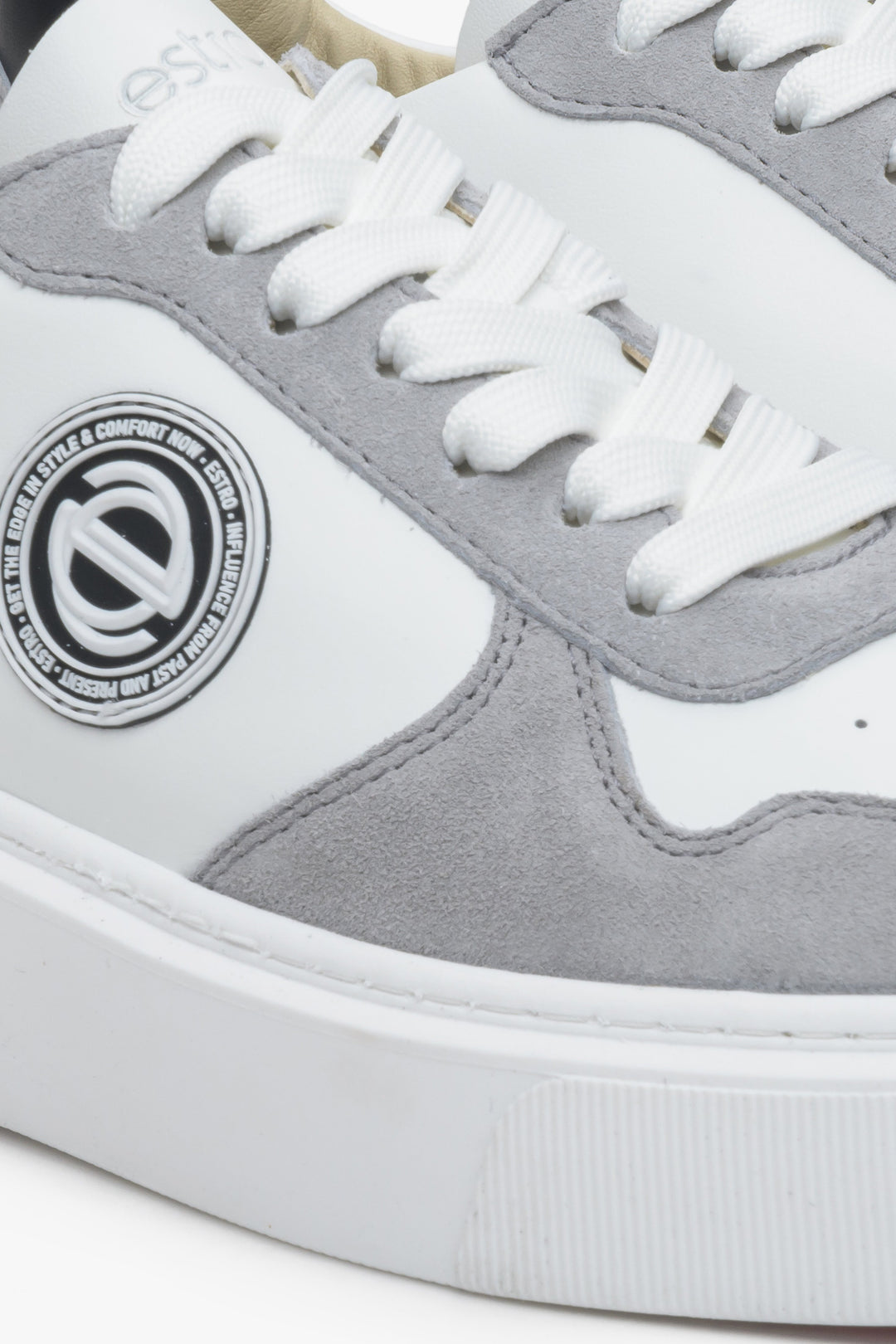 Leather women's sneakers by Estro in white and grey color with laces - close-up on the details.