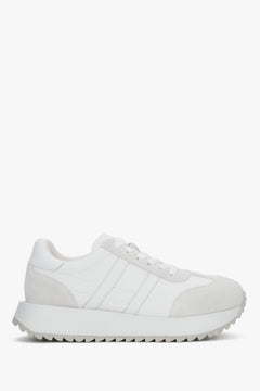 A pair of women's white sneakers crafted from genuine leather and suede.